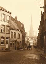 Leonard Misonne - A Cobblestone Brussels Street with Horse Carriages