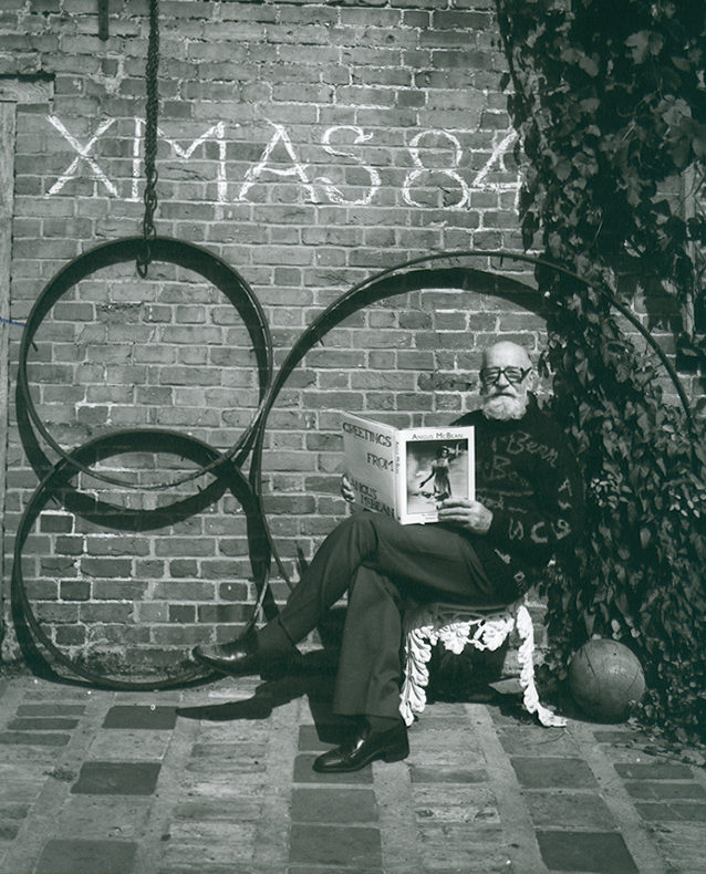 Angus McBean - Christmas Card 1984 - Self Portrait, Reading His Own Book in a Garden Angus McBean - Christmas Card 1984 - Self Portrait, Reading His Own Book in a Garden