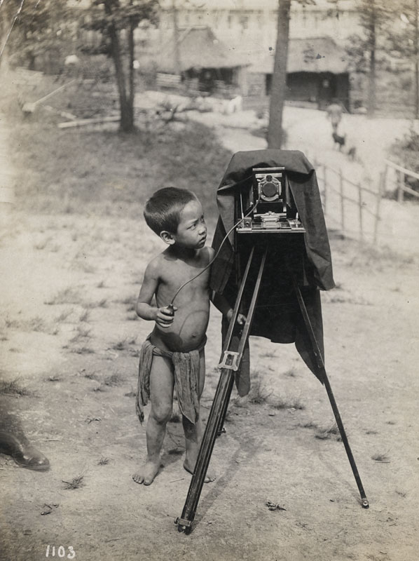 Igorot Boy Standing Beside Camera on Tripod, St. Louis Fair"