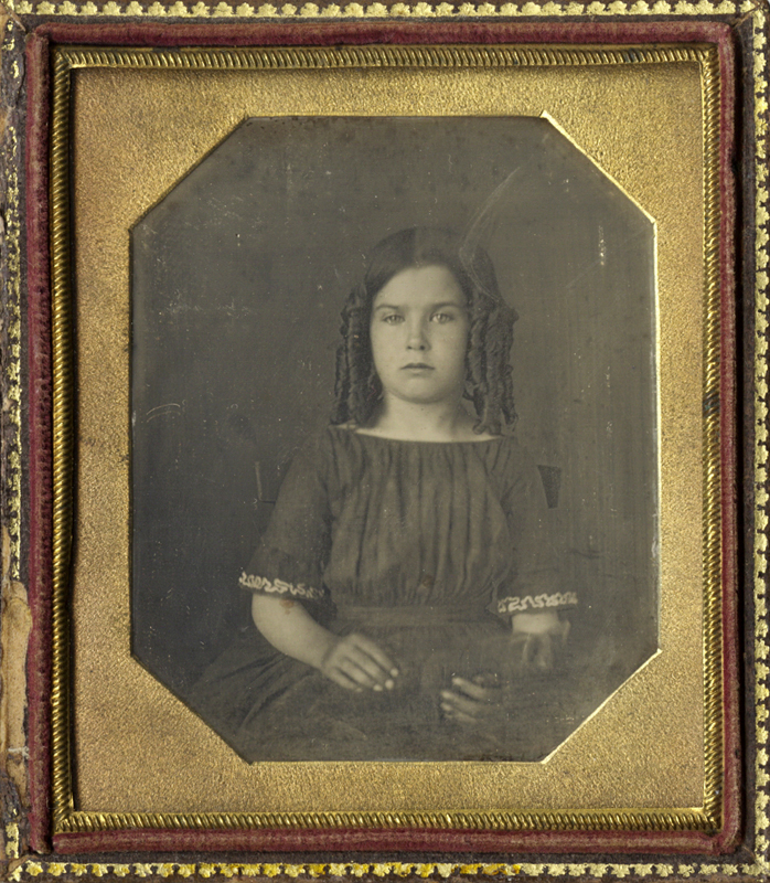 Studio Portrait of a Girl with Ringlets Holding Her Cat