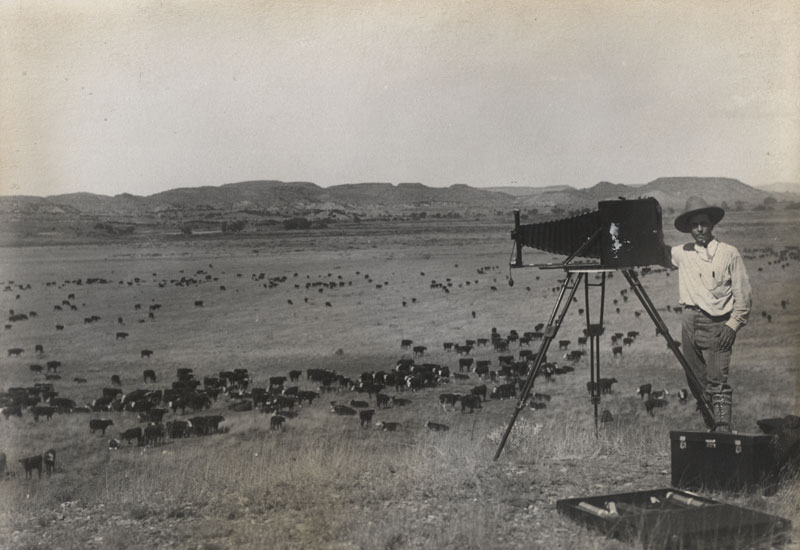 B. Clinton Bortel - Portrait with Camera, Overlooking Range Filled with Cattle