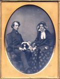 Chase - Portrait of a Seated Couple Posed with Their Dog Between Them