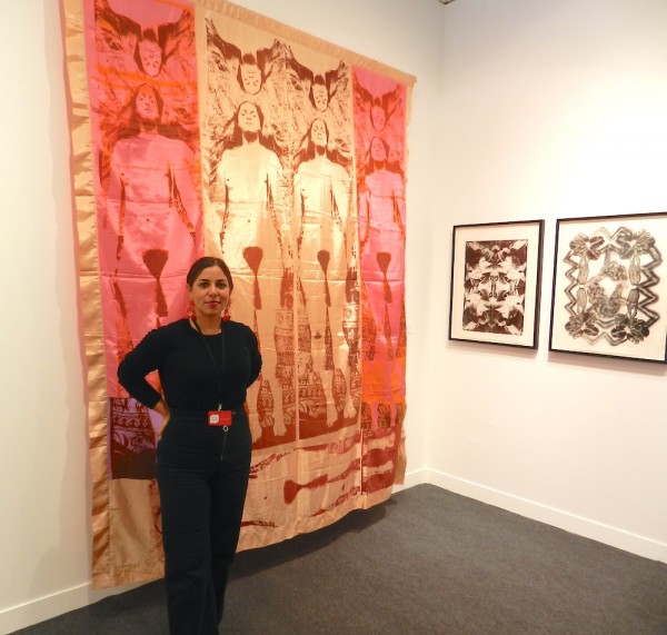 Cassandra Johnson at Steven Kasher in front of Joan Lyons 1970s work on fabric.