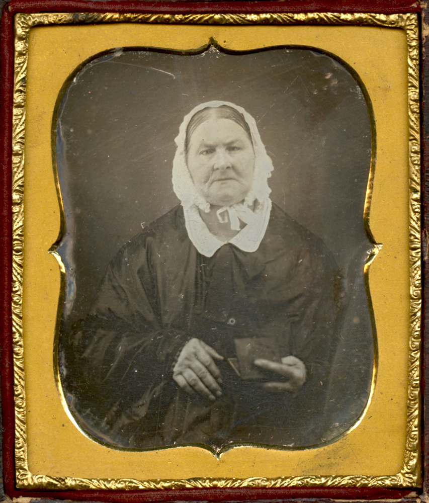 Anonymous - Old Woman Wearing a Bonnet, Holding a Daguerreotype Anonymous - Old Woman Wearing a Bonnet, Holding a Daguerreotype