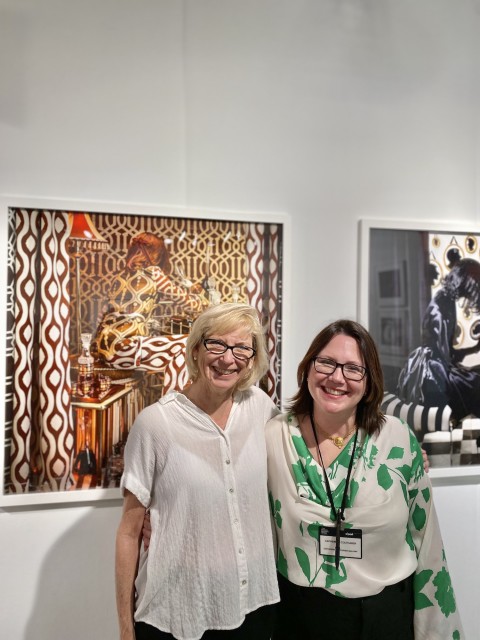 The artist Patty Carroll and Cat Couturier in front of the work, Red, Red Wine.