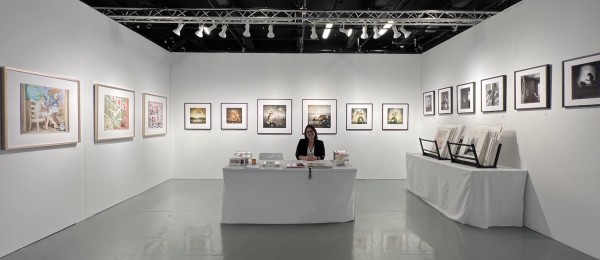 Houston's Cat Couturier in her booth at AIPAD.