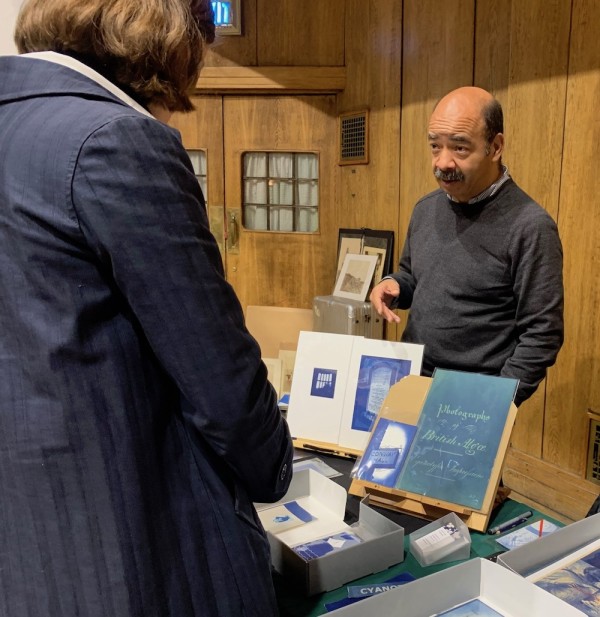 Anthony Jones showing off his cyanotypes. (Photo by Michael Diemar)