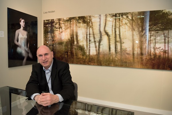 Exhibitor Alex Novak of Contemporary Works/Vintage Works in front of images by Lisa Holden. (Photo courtesy of Julienne Schaer and L'Oeil de la Photographie) Exhibitor Alex Novak of Contemporary Works/Vintage Works in front of images by Lisa Holden. (Photo courtesy of Julienne Schaer and L'Oeil de la Photographie)