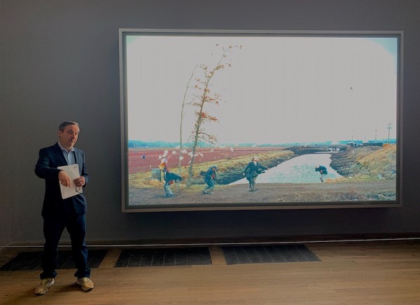Curator Gregor Muir, with Jeff Wall’s "A Sudden Gust of Wind".