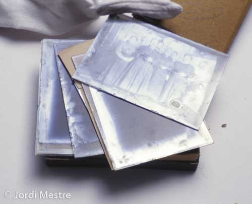Silver gelatin glass plates just removed from the typical board box. The plate on top has silver mirroring all over the surface, and the ones in the middle have mirroring mostly along their perimeters. (Photo Copyright Jordi Mestre i Vergés)